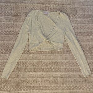 A long sleeve cropped top by Out From Under. Cropped above the waist.